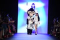 Designer Jia Liu and mascott walk the runway at the Comme Tu Es fashion show