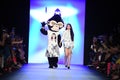 Designer Jia Liu and mascott walk the runway at the Comme Tu Es fashion show