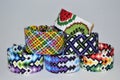 Designer new unique colorful and multi-colored friendship bracelets handmade of embroidery bright floss and thread with knots isol Royalty Free Stock Photo
