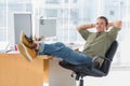 Designer relaxing with foot on the desk Royalty Free Stock Photo
