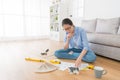 Designer sitting on living room wooden floor