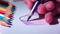 Designer smooth strokes complements blue pencil sketch. Close up. Slow motion