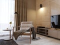 Designer soft armchair with wooden legs and a knitted blanket thrown over, near the TV unit in a modern bedroom