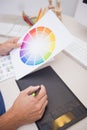 Designer using graphics tablet and colour wheel Royalty Free Stock Photo