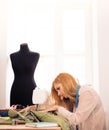 Designer using sewing machine in workshop Royalty Free Stock Photo