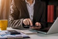 Designer using tablet with laptop and document on desk in modern office. Royalty Free Stock Photo