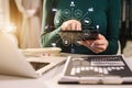 Designer using tablet with laptop and document on desk in modern office. Royalty Free Stock Photo