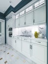 Designer white kitchen furniture in a classic style with blue walls