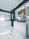 Designer white kitchen furniture in a classic style with blue walls