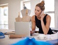 Designer, woman and phone call in studio for fashion with laptop, typing and communication for deal. Person, smartphone