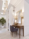Designer working and dressing table made of wood with a mirror in a gilded frame and glowing sconces on the wall in the suite Royalty Free Stock Photo