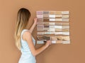 Designer works with pantone scale in art studio.