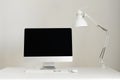 Designer workspace on grey background. Minimalistic home office. Copy space. Keyboard, mouse, computer display with black blank Royalty Free Stock Photo