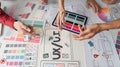 UX Design and Collaboration. Creative professionals brainstorming UIUX concepts on a design table.