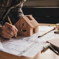 Designing Dreams. A Man Plans His Wooden House with Care. Royalty Free Stock Photo