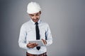 Designing made easy. a well-dressed civil engineer using his tablet while standing in the studio. Royalty Free Stock Photo