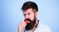 Desire concept. Oral pleasure. Man handsome strict face hipster with long beard try strawberry. Hipster enjoy juicy Royalty Free Stock Photo