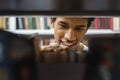 Portrait of black guy looking for interesing book Royalty Free Stock Photo