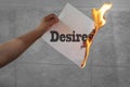 Desires text on fire on paper