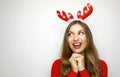 Desirous hopeful young woman with reindeer horns on her head loo