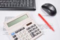 Desk accountant closeup: invoice, keyboard, calculator, mouse, and red pen Royalty Free Stock Photo