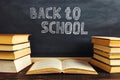 Desk against the background of chalk boards and books. Copy space Royalty Free Stock Photo