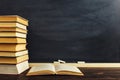 Desk against the background of chalk boards and books. Copy space Royalty Free Stock Photo