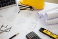 Desk of Architectural working solar panel home project in construction site,With drawing equipment concept