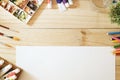 Desk of artist color pencils and paper on wood table. Royalty Free Stock Photo