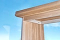 Desk with bleached solid oak stands on a cork floor against the sky outside the window