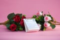 Desk calendar for February 2024 on a pink background with roses Royalty Free Stock Photo