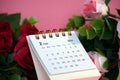 Desk calendar for February 2024 on a pink background with roses Royalty Free Stock Photo