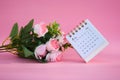 Desk calendar for February 2024 on a pink background with roses Royalty Free Stock Photo