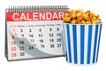 Desk calendar with popcorn container. Movie releases calendar concept, 3D rendering