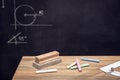 Desk with chalk, eraser and Blackboard with geometry drawings Royalty Free Stock Photo