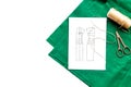 Desk of clothing designer. Green textile and pattern of clothing on white background top view copyspace