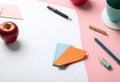 a desk with a cup of coffee, pencils, and an apple Royalty Free Stock Photo