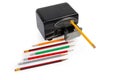 Desk electric pencil sharpener and pencils on a white background Royalty Free Stock Photo