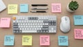 Desk features a mechanical keyboard a white mouse and several Royalty Free Stock Photo
