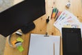 desk of graphic designer at work - digital tablet, computer screen, color swatch catalog samples for selection. Creativity Editor