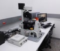 Desk with a high-tech microscopy station, fluorescence microscope, in laboratory