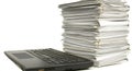 A desk holds a laptop computer and a stack of paperwork documents Royalty Free Stock Photo