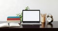 Desk with laptop books and alarm clock Royalty Free Stock Photo