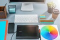 The gray desk with laptop, notepad with blank sheet, pot of flower, stylus and tablet for retouching Royalty Free Stock Photo