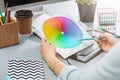 The gray desk with laptop, notepad with blank sheet, pot of flower, stylus and tablet for retouching Royalty Free Stock Photo