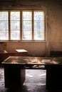 Desk with long forgotten documents in abandoned room