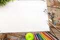 A desk with many stationery items placed,Large blank paper to put different content messages Royalty Free Stock Photo