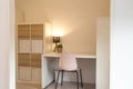 Desk in modern organized white room, home interior with, green plant and lamp