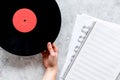 Desk of musician or dj with vynil records and blank paper for songwriter work on stone background top view mockup