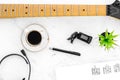 Desk of musician for songwriter work with headphones, keyboard, guitar and notes marble background top view Royalty Free Stock Photo